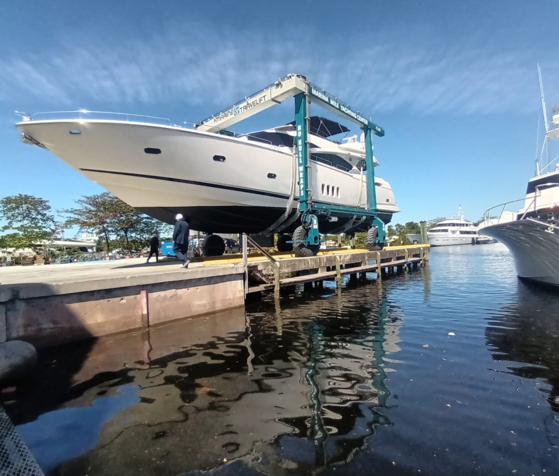 A motor yacht in the slings of a travel lift for a pre-purchase survey