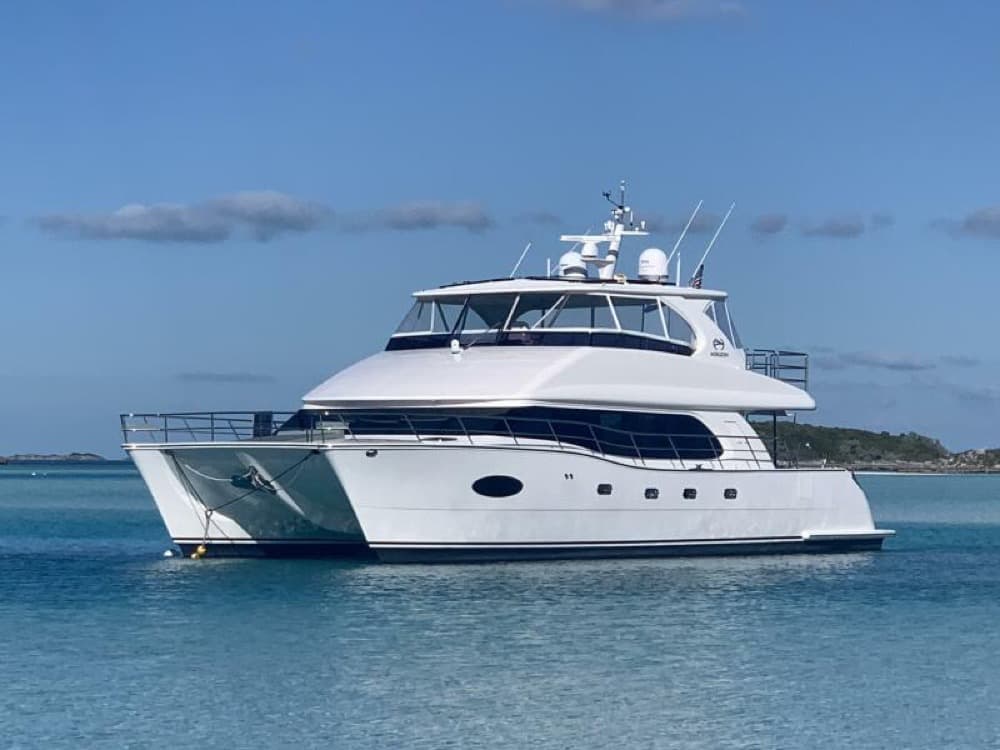 A power catamaran lying at anchor
